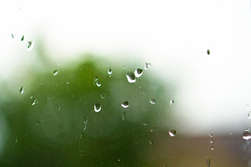 Fresh weather outside the window after the rain with drops on the window. rainy nature of autumn and summer days. Cool spring conditions. Stock photos