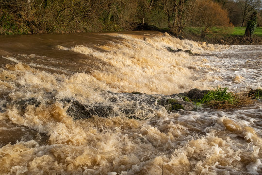 The weir at Tipton St John, Devon, England on the River Otter at fiull force with all the rain dropped by Storm Gareth,