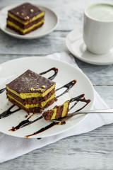 piece of Austrian three-layer cake on a white plate in a cafe