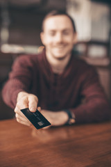 Visitor pays with a credit card in a cafe