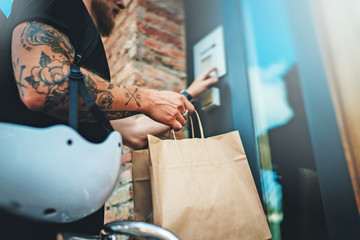 Courier delivery food service at home. Man courier delivered the order no name bag with food.