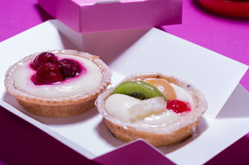 Two cream cakes with fruit. Two round cakes.