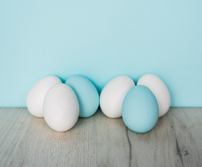 Spring and Easter holiday concept. Easter eggs painted blue and white, pastel color background. Isolated on white.