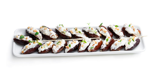 Dates stuffed with cream cheese and almonds isolated on white