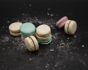 colored macaroons on a black background