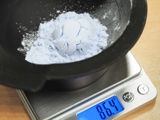 Weighing the powder in a bowl on the scales.