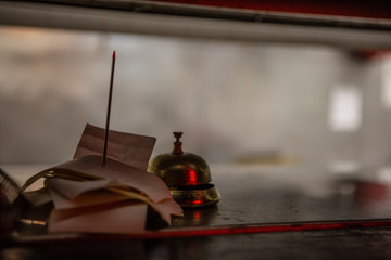 Tickets and a bell wait in a food window