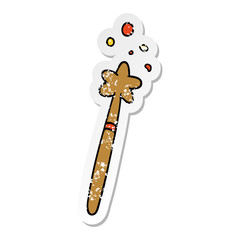 distressed sticker cartoon doodle of a magic wand