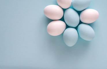 Spring and Easter holiday concept. Easter eggs painted blue and white, pastel color background. Isolated on white.