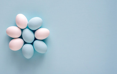Spring and Easter holiday concept. Easter eggs painted blue and white, pastel color background. Isolated on white.