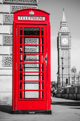 Fototapeta na wymiar London's iconic telephone booth with the Big Ben clock tower in the background