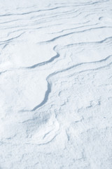 Fresh snow background texture. Winter background with snowflakes and snow mounds. Snow lumps.