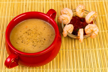Lobster Chowder in Red Bowl and Shrimp Cocktail on Bamboo Mat