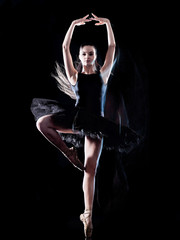 Fototapeta premium one caucasian young woman ballerina dancer dancing isolated on black background with light painting motion blur speed effect