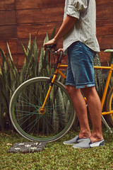 Naklejka premium Attractive man standing with old bicycle.