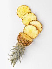 Juicy pineapple, cut into pieces on a ligth background. Top view.