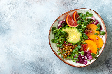 Vegan, detox Buddha bowl with turmeric roasted  chickpeas, greens, avocado, persimmon, blood...