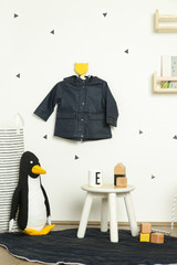 Cute corner in the nursery room in white, black and yellow colors