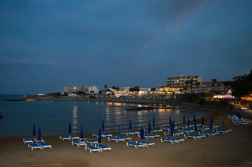 Fototapeta na wymiar Night walking along wharf near Louma Beach at in Pernera, Cyprus on June 16, 2018. 
