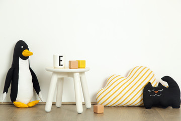 Cute corner in the nursery room in white, black and yellow colors