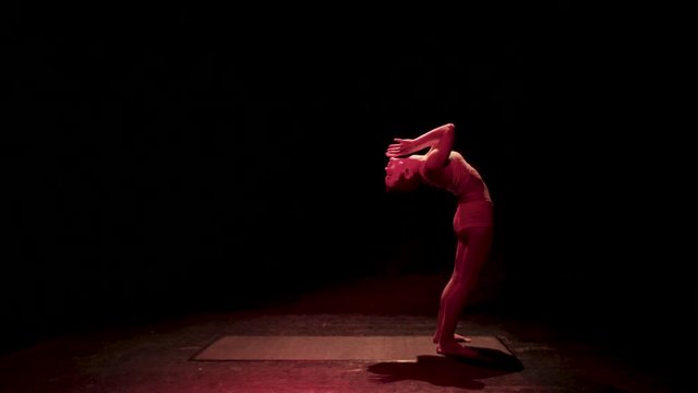 Female contortionist circus performer performing on stage