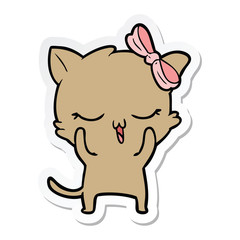 sticker of a cartoon cat with bow on head