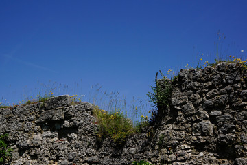 Fototapeta na wymiar broken down castle wall and blue sky