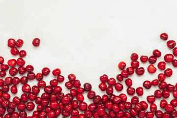 Fresh cherry lies in the lower part of the image on a light stone background. Concept of harvest. Flat lay, top view