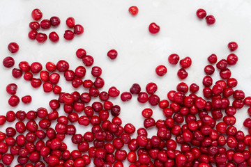 Fresh cherry lies in the lower part of the image on a light stone background. Concept of harvest. Flat lay, top view