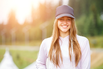 Outdoors portrait of beautiful young smiling woman