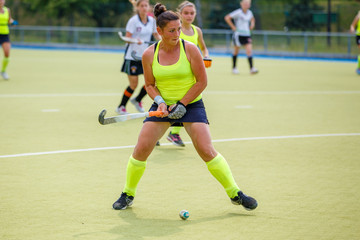 Fototapeta premium Young hockey player woman with ball in attack