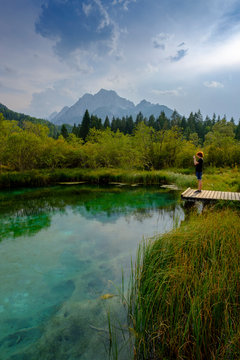 Slovenia, Gorenjska, near Ratece, Sava Dolinka, source, Lake Zelenci, young man standing on jetty