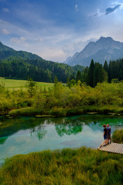 Slovenia, Gorenjska, near Ratece, Lake Zelenci, father and son on jetty
