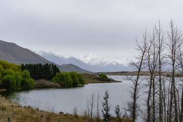 Fototapeta na wymiar lake in the mountains, mountains on the horizon covered by snow, foggy landscape
