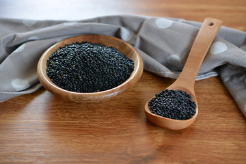 raw black lentils in a bowl