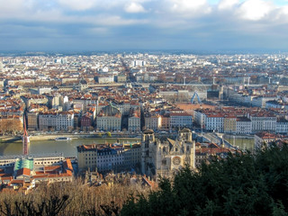Obraz premium Aerial view of a cityscape of downtown Lyon in France with plenty of red roofs and white old buildings