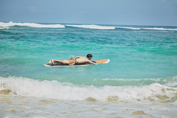 Surfer man with surfboard enjoying on the beach. Summer concept.