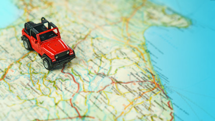 Travel on the road with map. Car travel and road trip. Concept of journey and rent a car, lifestyle. Selective focus, close-up, copy space.