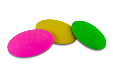 Pink, yellow and green color soft erasers, isolated on white background