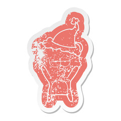 bored bear cartoon distressed sticker of a wearing santa hat