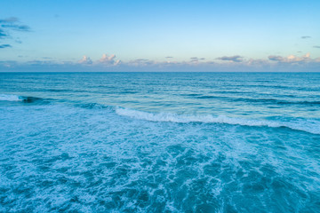 Ocean waves and clear sky at dawn with copy space