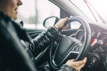 Female car driver rides on a sunny day. Travel concept