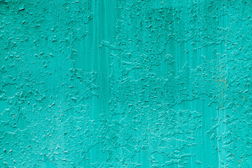 Imperfect metallic plate. Cracked paint close-up. Damage texture in macro. Grungy metal panel. Textured background. Rough faded uneven iron wall. Obsolete surface. Peeling of old paint. Flaking of dye