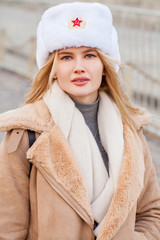 Portrait of a young beautiful girl in a white hat