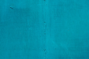 Imperfect metallic plate. Cracked paint close-up. Damage texture in macro. Grungy metal panel. Textured background. Rough faded uneven iron wall. Obsolete surface. Peeling of old paint. Flaking of dye