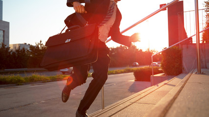 CLOSE UP: Male corporate professional rushing to a meeting after oversleeping.
