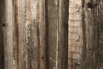 Old wooden unpainted boards. Vertical view. Close-up. Background. Texture.