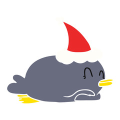 penguin lying on belly wearing santa hat
