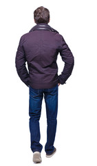 Back view of going  handsome man in jeans and winter jacket. © ghoststone