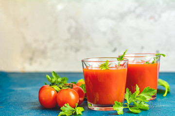 Delicious tomato bloody mary cocktail on dark blue concrete table